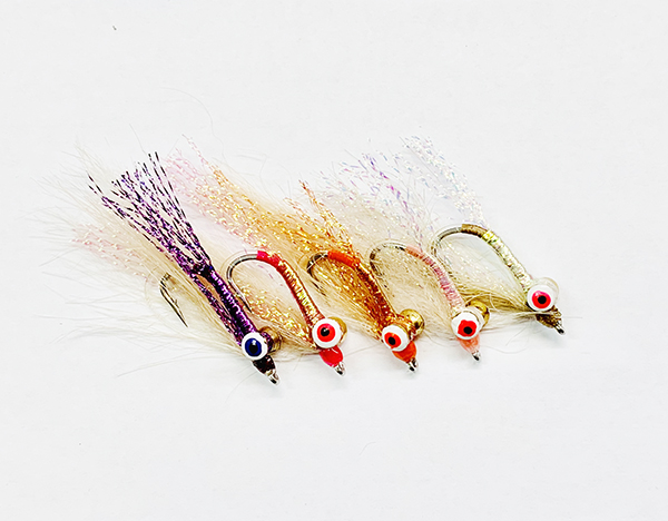 Christmas Island Special fly with flashy body, bead chain eyes, and wing fibers for saltwater fishing.