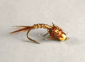 Lightning Bug Tungsten is a highly effective nymph pattern featuring a flashy, metallic body and a tungsten bead for rapid sink rate.