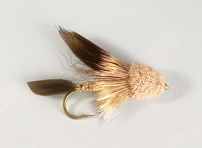 Muddler Minnow streamer with natural colors and deer hair head, a versatile fly for imitating sculpins, minnows, and aquatic insects.