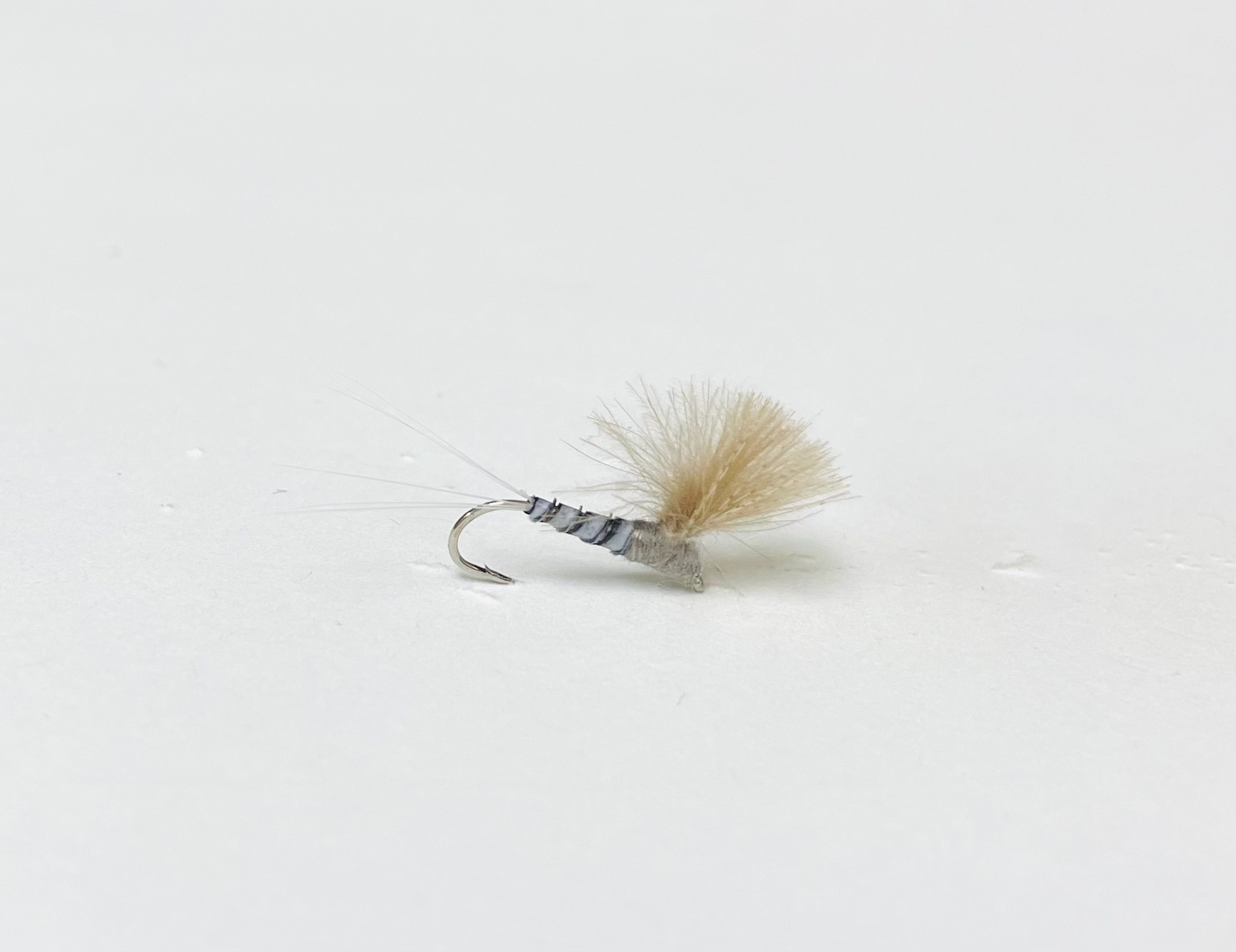 The Blue Dun Parachute CDC is a beautifully tied dry fly that imitates the adult stage of the Blue Dun mayfly, also known as a Blue-Winged Olive. Fly fishing flies.