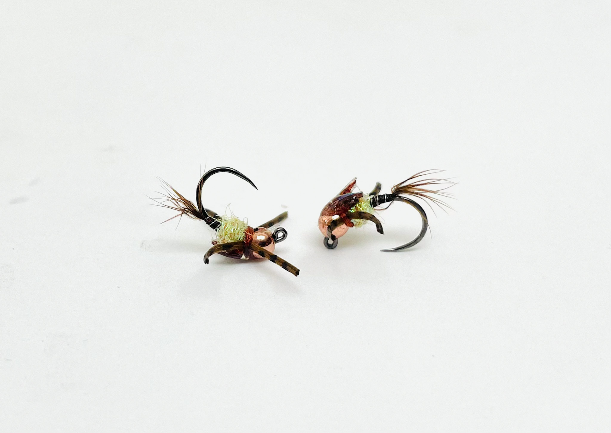 NY Baetis Lite Tungsten Jig Hook with slim pale body and tungsten bead, imitating small mayfly nymphs for trout fishing.