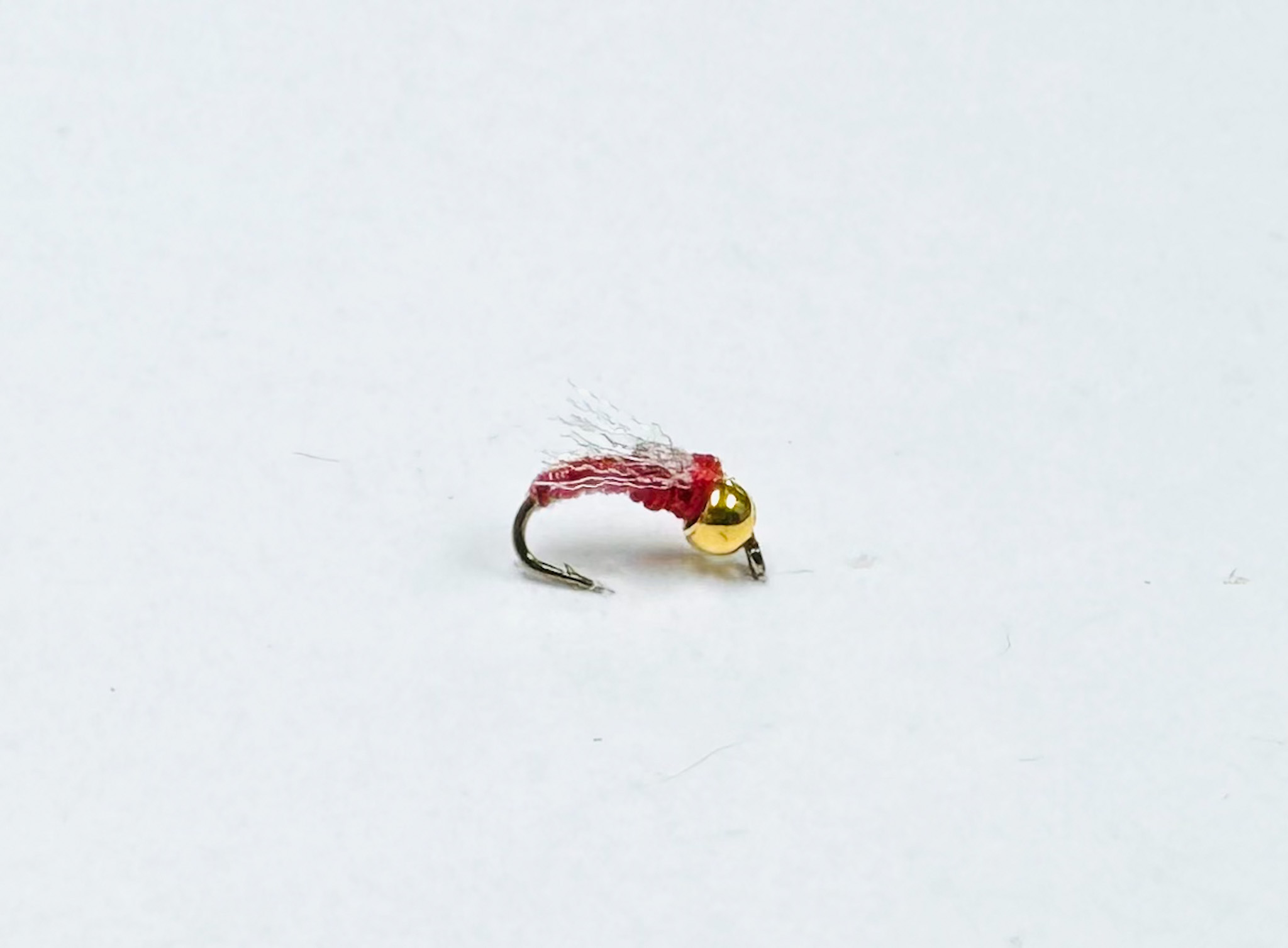 Jujubee Red Bead Head is a deadly midge fly designed for clear, cold waters where trout key in on tiny insects