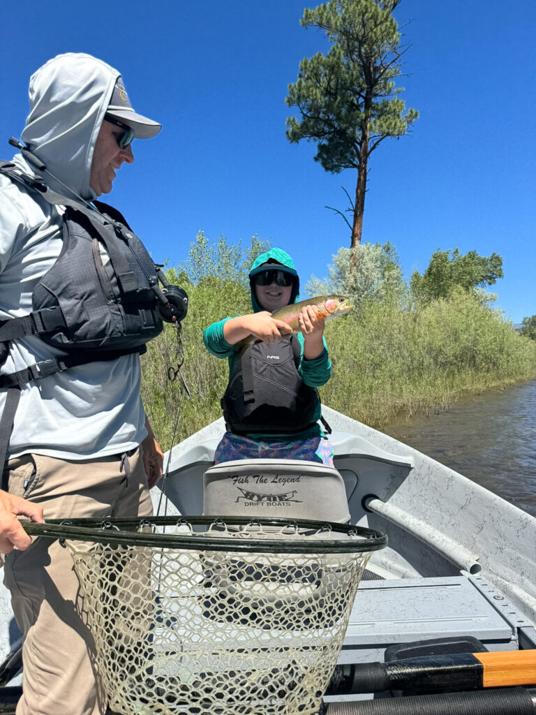 Brandon guiding float trip. Man with nice trout catch